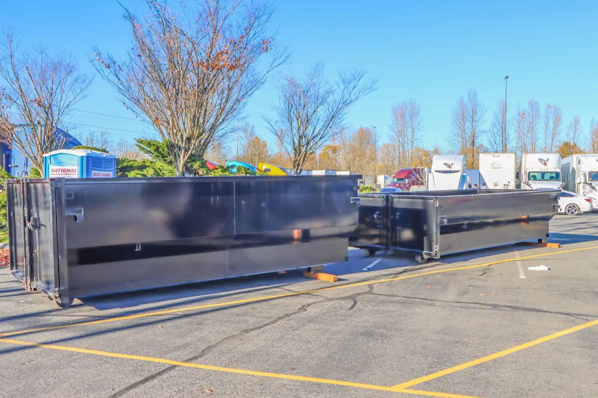 Professional dumpster rental service with roll-off container on residential driveway in Finley
